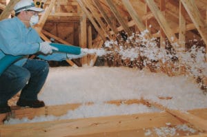 Contractor using white blown in wool for home attic